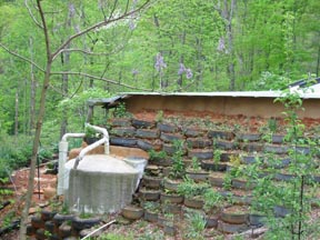 Main entrance to the Stones' Earthship on the west side. Gardens of 